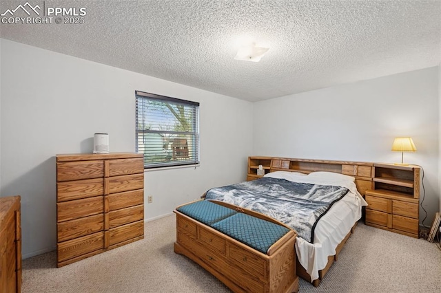 bedroom featuring a textured ceiling and carpet