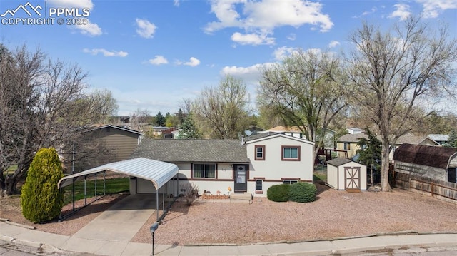 tri-level home with stucco siding, a shed, driveway, an outdoor structure, and a carport