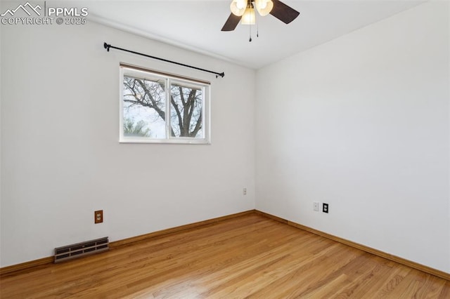 spare room with ceiling fan, baseboards, light wood finished floors, and visible vents