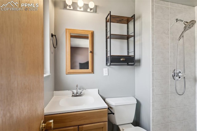 full bathroom featuring vanity, toilet, and tiled shower