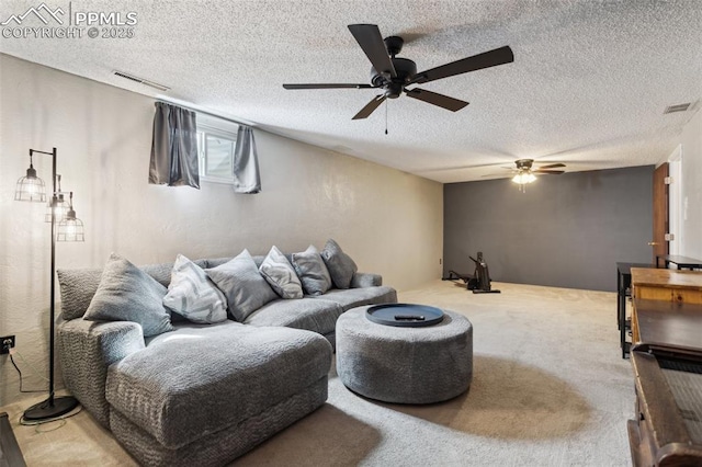 living area with visible vents, carpet, a textured ceiling, and ceiling fan