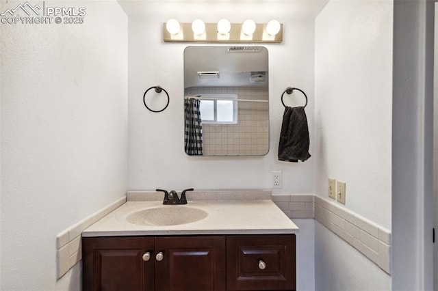 bathroom with vanity and curtained shower