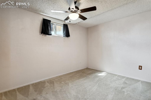 carpeted spare room featuring a ceiling fan, baseboards, and a textured ceiling