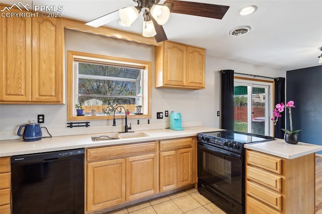 kitchen featuring a sink, black appliances, a healthy amount of sunlight, a peninsula, and visible vents