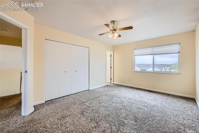 unfurnished bedroom with ceiling fan, a closet, baseboards, and carpet floors