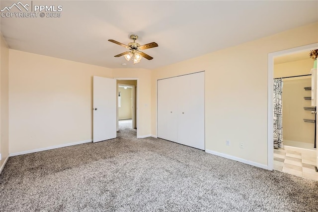 unfurnished bedroom with carpet flooring, ceiling fan, ensuite bath, and baseboards