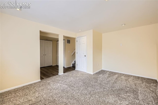 carpeted spare room with stairway, visible vents, recessed lighting, and baseboards