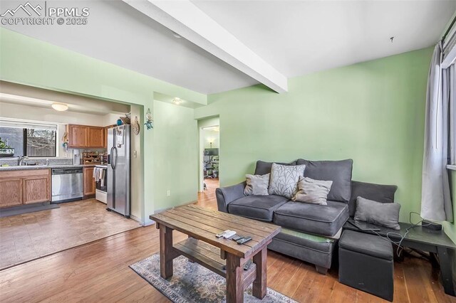627 E Las Animas St, Colorado Springs, CO 80903 - living room with light wood-type flooring and beamed ceiling