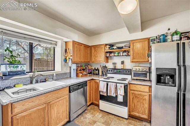 627 E Las Animas St, Colorado Springs, CO 80903 - kitchen featuring a sink, stone finish flooring, open shelves, light countertops, and appliances with stainless steel finishes