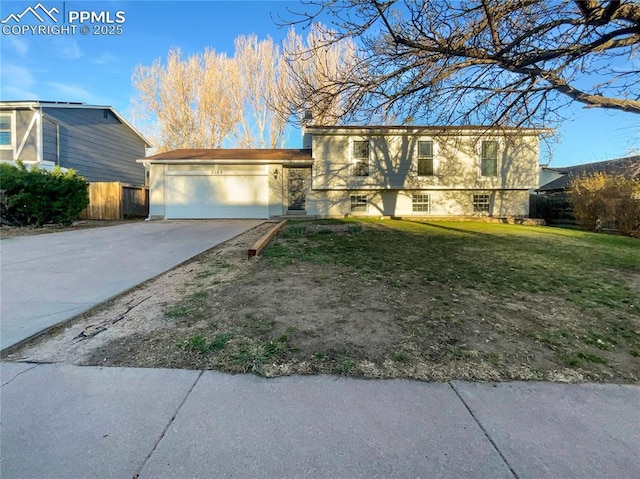 view of front of house featuring driveway, an attached garage, fence, a front yard, and stucco siding