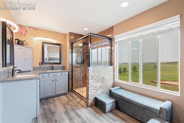 11960 S Conestoga Trl, Elbert, CO 80106 - bathroom featuring double vanity, a shower stall, wood finished floors, and recessed lighting
