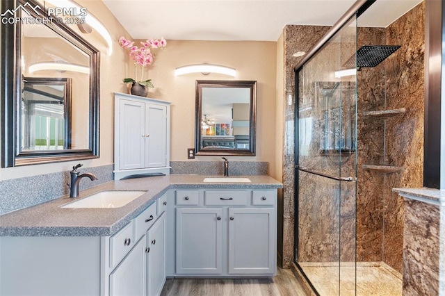 11960 S Conestoga Trl, Elbert, CO 80106 - full bathroom with double vanity, a shower stall, and wood finished floors