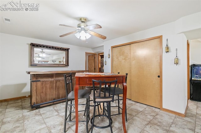 11960 S Conestoga Trl, Elbert, CO 80106 - dining room featuring ceiling fan, a dry bar, and baseboards