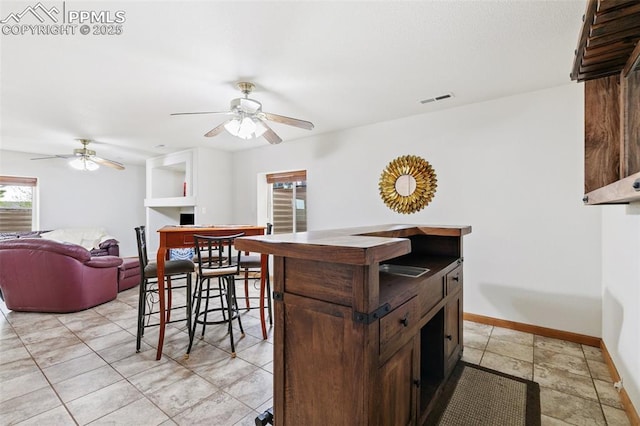11960 S Conestoga Trl, Elbert, CO 80106 - kitchen featuring ceiling fan, baseboards, and dark brown cabinets