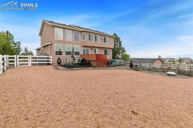 11960 S Conestoga Trl, Elbert, CO 80106 - back of house with a fenced backyard and stucco siding