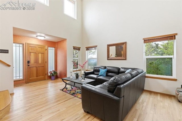 11960 S Conestoga Trl, Elbert, CO 80106 - living room with a towering ceiling, light wood finished floors, and baseboards