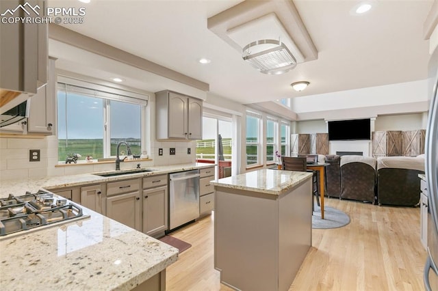 11960 S Conestoga Trl, Elbert, CO 80106 - kitchen with a sink, appliances with stainless steel finishes, a center island, light wood-type flooring, and recessed lighting