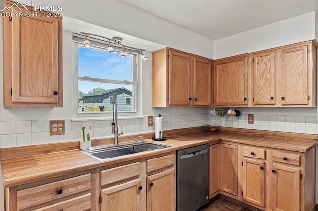 7390 Windy Peak Dr, Colorado Springs, CO 80911 - kitchen with stainless steel dishwasher, a sink, and tasteful backsplash