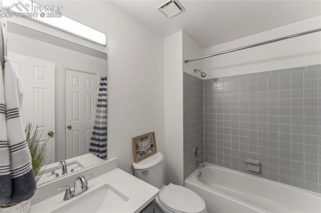 bathroom featuring shower / bath combination with curtain, toilet, vanity, and visible vents