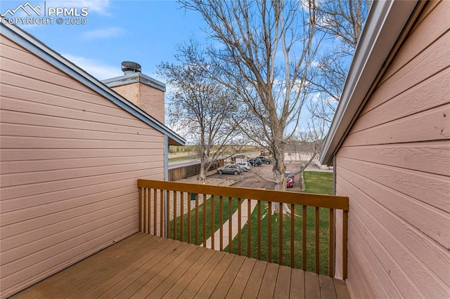wooden deck featuring a lawn