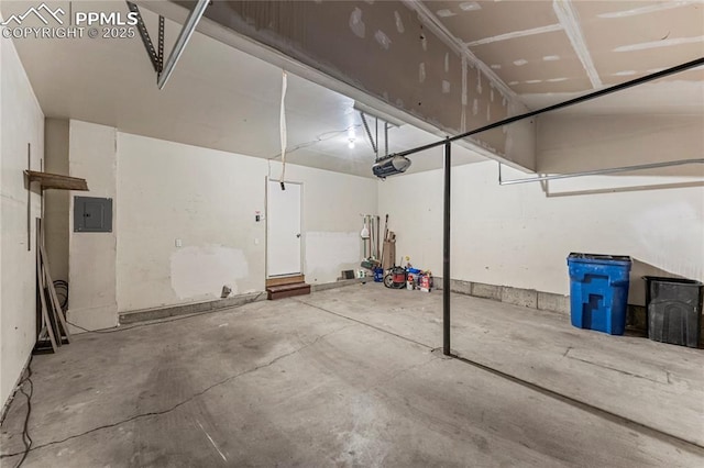 garage featuring electric panel and a garage door opener
