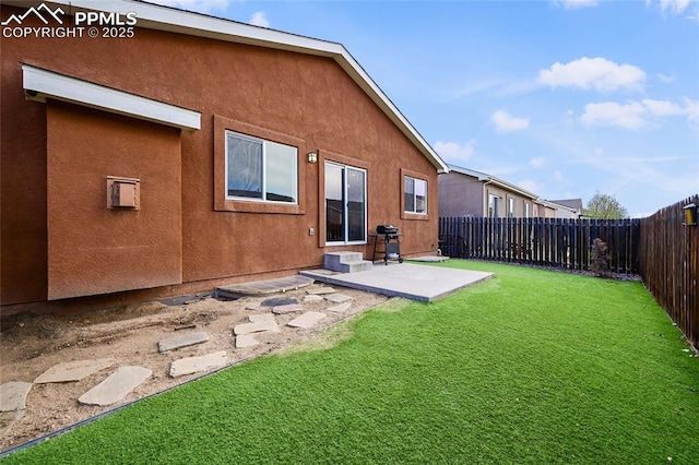 11584 Louvre Pt, Peyton, CO 80831 - back of property with a patio, a fenced backyard, stucco siding, and a yard