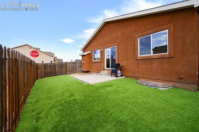 11584 Louvre Pt, Peyton, CO 80831 - back of house with a fenced backyard, stucco siding, a yard, and a patio area