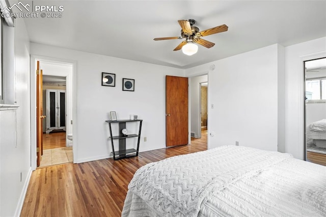 bedroom featuring baseboards, ceiling fan, and wood finished floors