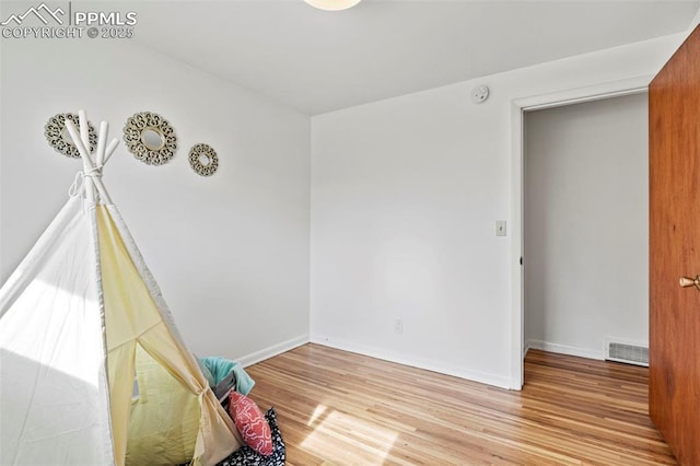 unfurnished room with light wood-type flooring, baseboards, and visible vents