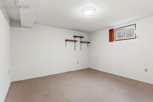 spare room with a textured wall