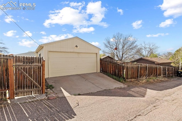 detached garage featuring a gate and fence