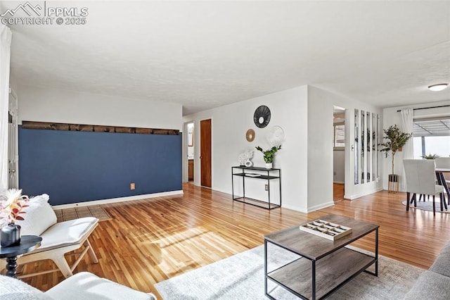 living room with baseboards and wood finished floors