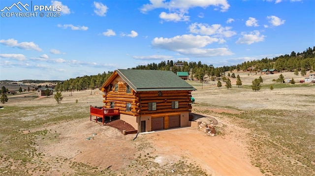 654 High Pasture Rd, Florissant, CO 80816 - view of home's exterior featuring log siding, driveway, a garage, and a view of rural / pastoral area