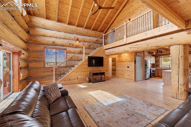 654 High Pasture Rd, Florissant, CO 80816 - unfurnished living room with light wood-type flooring, wooden ceiling, high vaulted ceiling, beamed ceiling, and rustic walls