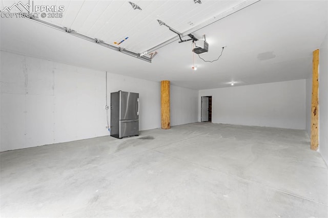654 High Pasture Rd, Florissant, CO 80816 - garage with freestanding refrigerator and a garage door opener