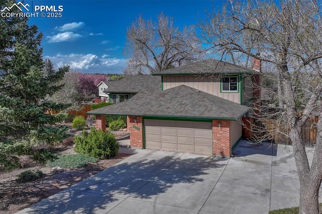 view of front of property featuring concrete driveway, a chimney, board and batten siding, a garage, and brick siding