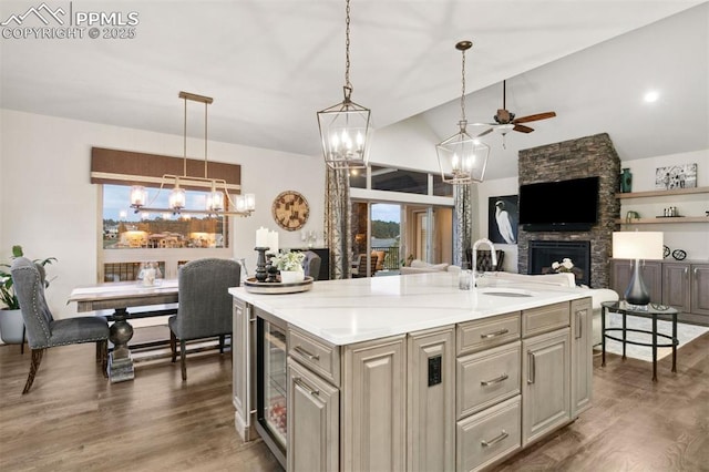 4043 Needles Dr, Colorado Springs, CO 80908 - kitchen with a stone fireplace, a sink, light countertops, ceiling fan with notable chandelier, and beverage cooler