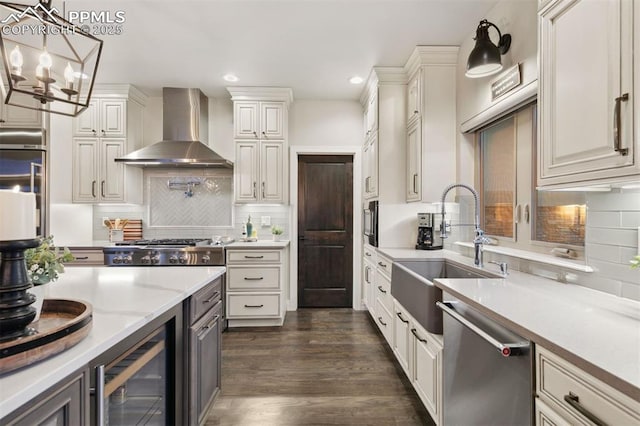 4043 Needles Dr, Colorado Springs, CO 80908 - kitchen featuring wall chimney range hood, a sink, dishwasher, beverage cooler, and recessed lighting