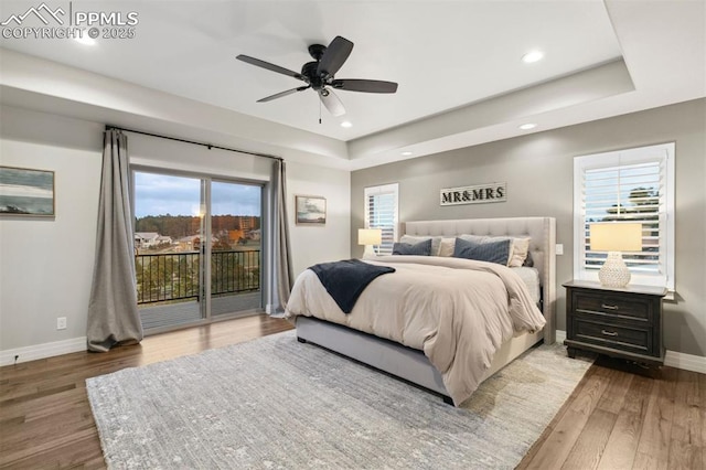 4043 Needles Dr, Colorado Springs, CO 80908 - bedroom featuring baseboards, a raised ceiling, hardwood / wood-style floors, and access to exterior