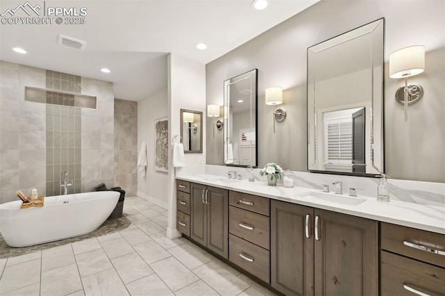 4043 Needles Dr, Colorado Springs, CO 80908 - bathroom featuring visible vents, a sink, a freestanding bath, and double vanity