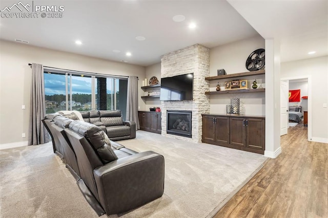 4043 Needles Dr, Colorado Springs, CO 80908 - living room with visible vents, baseboards, a stone fireplace, recessed lighting, and light wood-style flooring