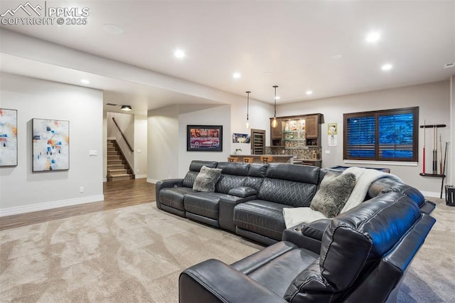 4043 Needles Dr, Colorado Springs, CO 80908 - living room featuring light colored carpet, stairs, baseboards, bar area, and recessed lighting