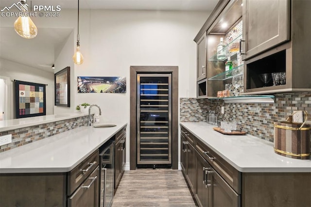 4043 Needles Dr, Colorado Springs, CO 80908 - bar featuring beverage cooler, a sink, backsplash, and light wood-type flooring