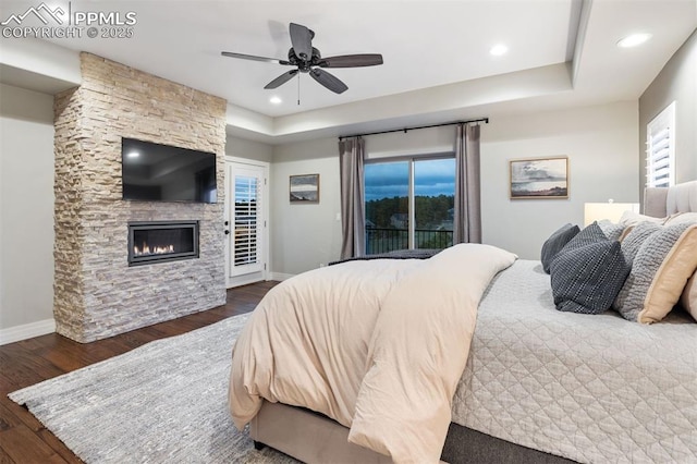 4043 Needles Dr, Colorado Springs, CO 80908 - bedroom featuring a fireplace, access to exterior, recessed lighting, baseboards, and wood finished floors
