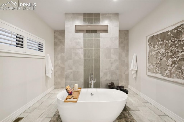 4043 Needles Dr, Colorado Springs, CO 80908 - bathroom featuring a freestanding tub and baseboards