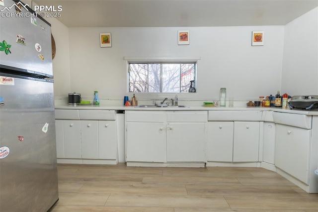 710 S Royer St, Colorado Springs, CO 80903 - kitchen with light countertops, freestanding refrigerator, a sink, and light wood-style floors