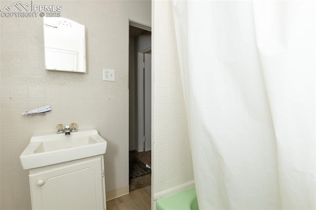 710 S Royer St, Colorado Springs, CO 80903 - full bath with tile walls, wood finished floors, and vanity