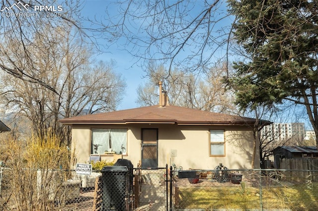 710 S Royer St, Colorado Springs, CO 80903 - back of house featuring stucco siding, a gate, and a fenced front yard