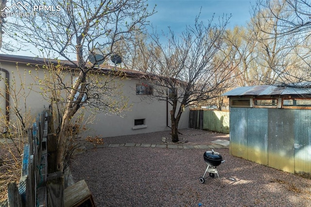 710 S Royer St, Colorado Springs, CO 80903 - view of property exterior featuring stucco siding, an outbuilding, and fence