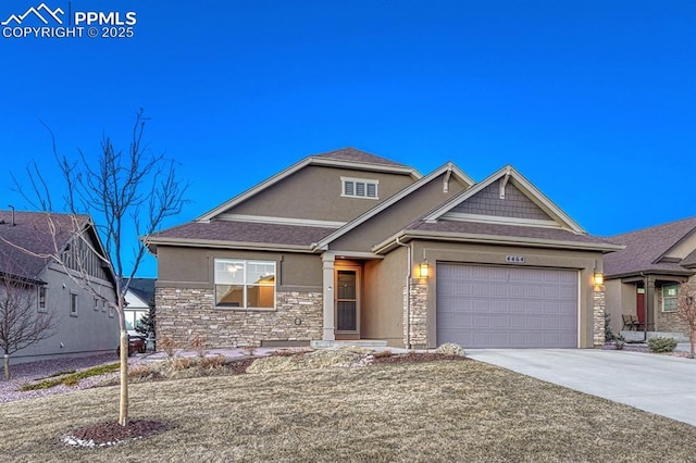 4464 Portillo Pl, Colorado Springs, CO 80924 - view of front facade with a garage, stucco siding, driveway, and stone siding